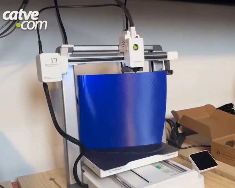 3D printer with a large blue part on the bed